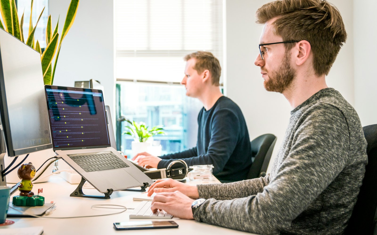 Two colleagues working together at a desk